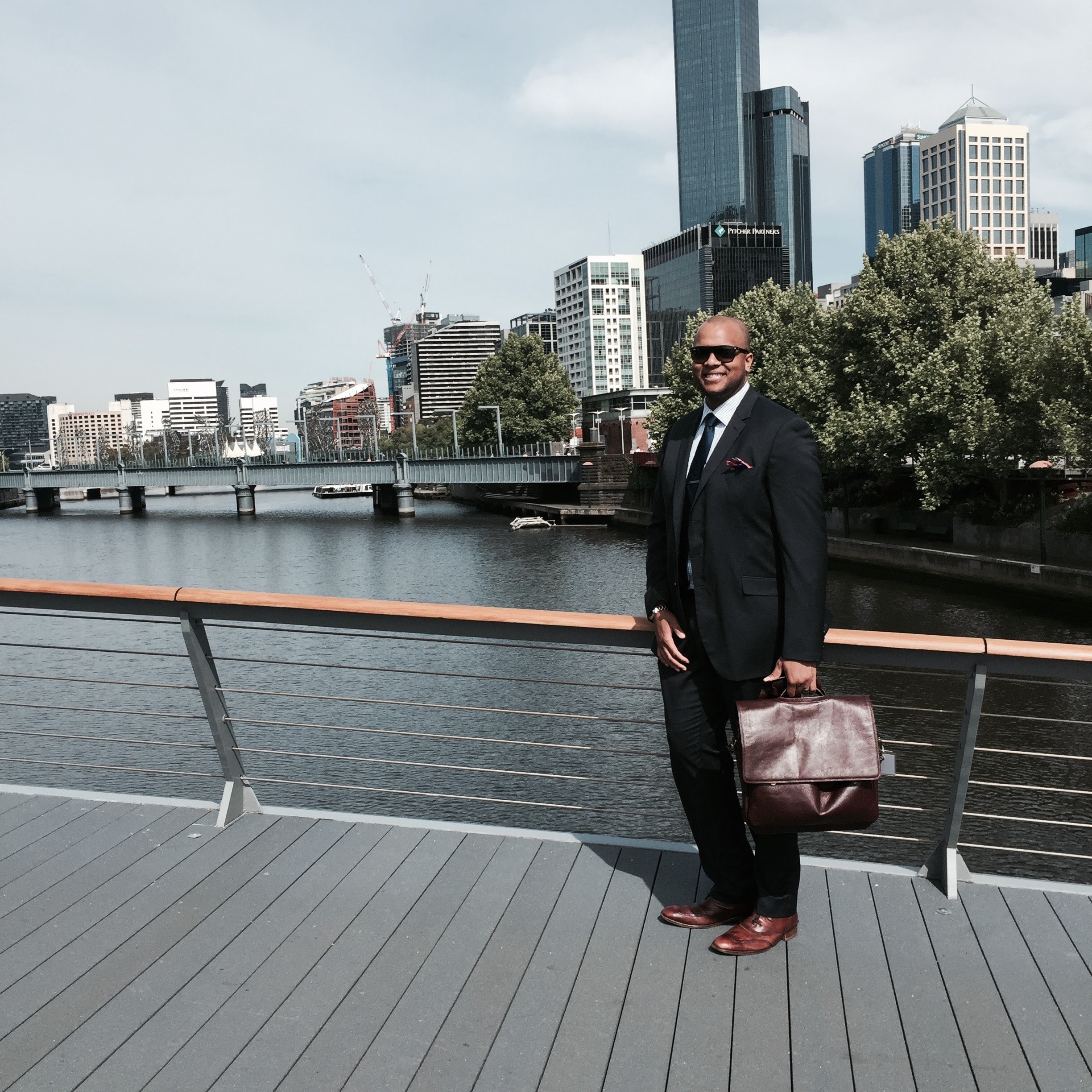 Phillip Rowell in business attire on a waterfront promenade in Melbourne, Australia